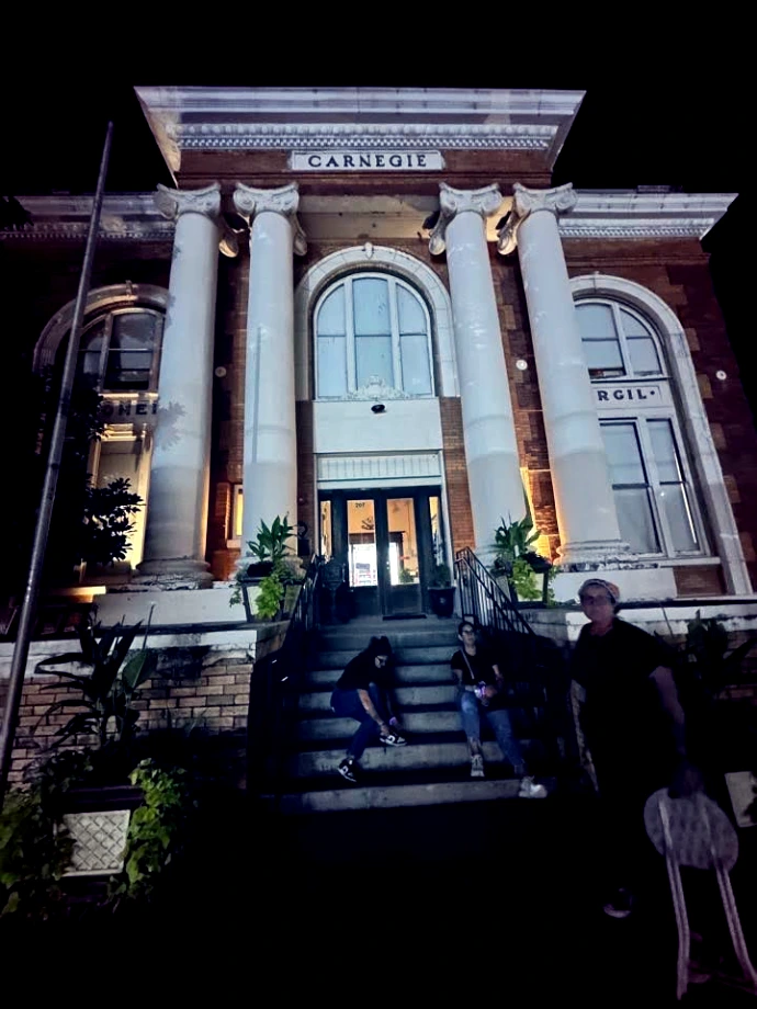 Haunted Terrell Heritage Museum at the historic Carnegie Library building at night with Ghost Walk guests
