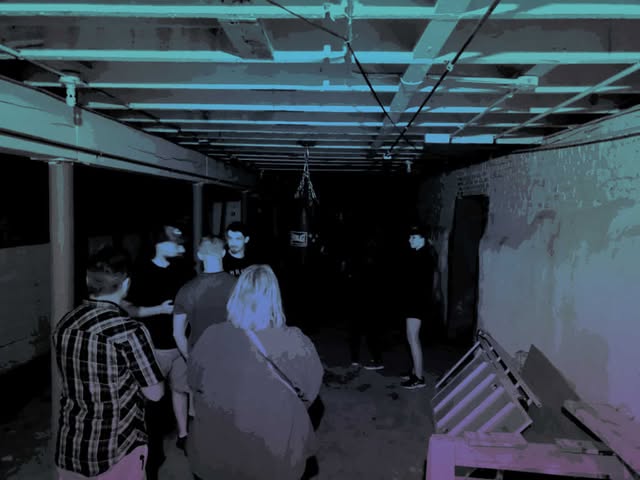Guests explore the Hardbodies basement that used to be a morgue during one of the terrell ghost tours