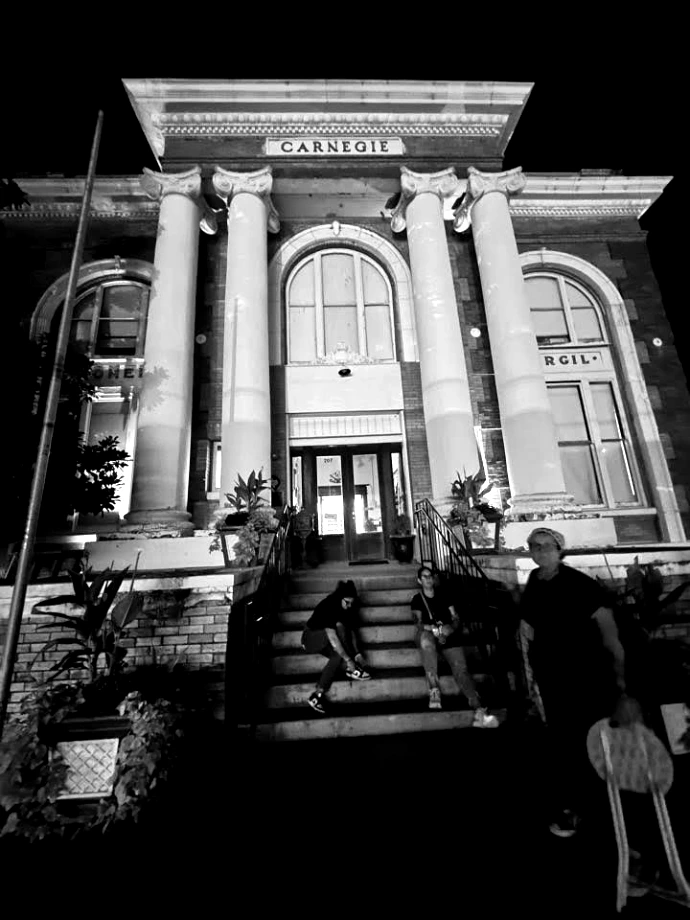 Haunted Terrell Heritage Museum at the historic Carnegie Library building at night with Ghost Walk guests